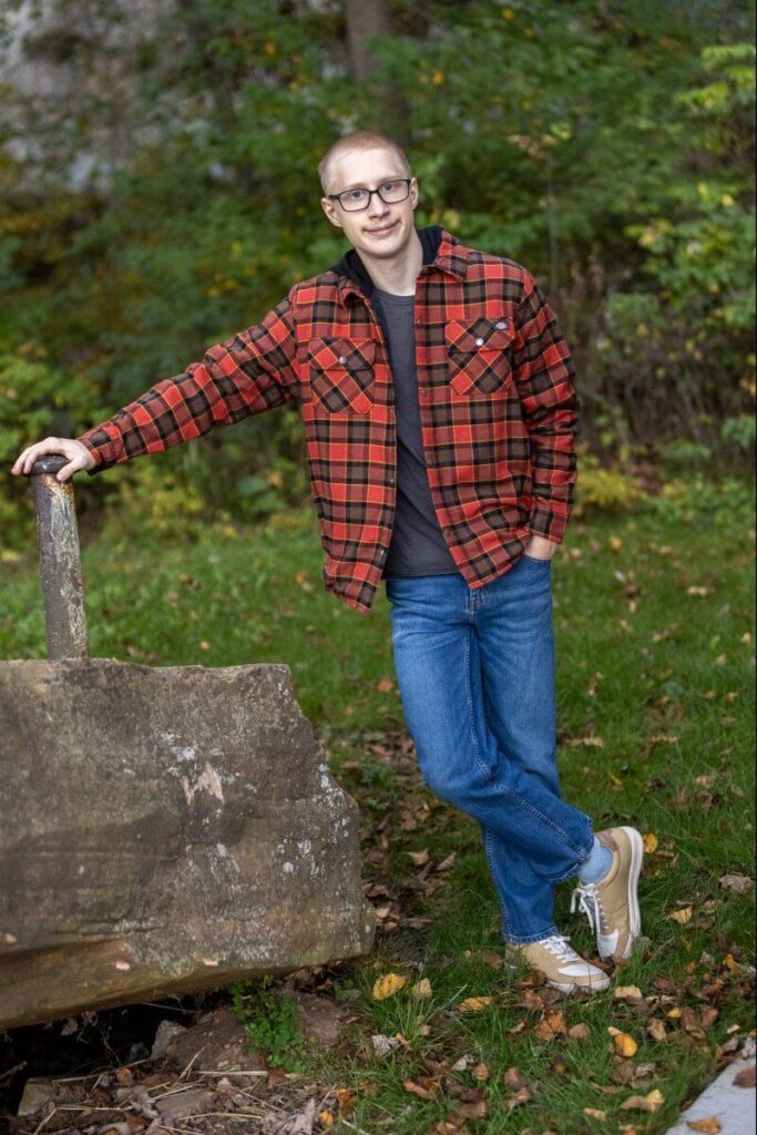 guy leaning on a pole