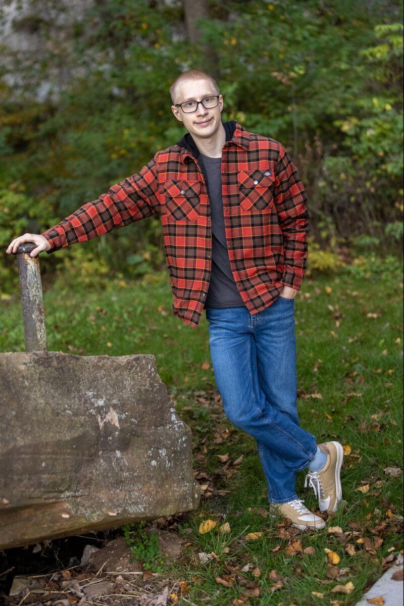 guy leaning on a pole