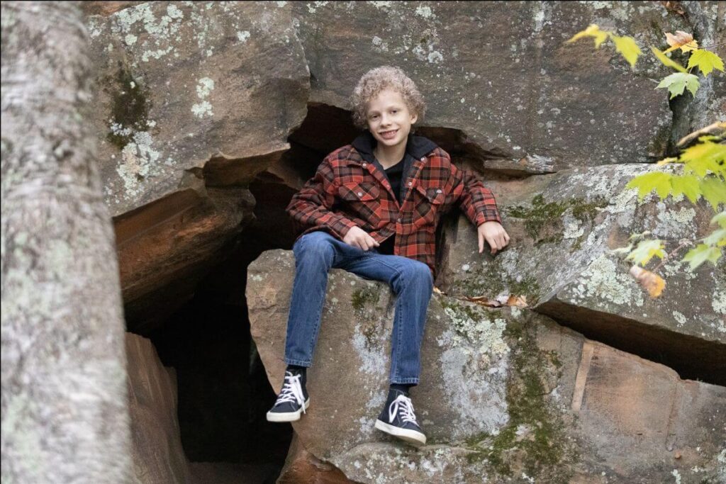 kid sitting on rocks