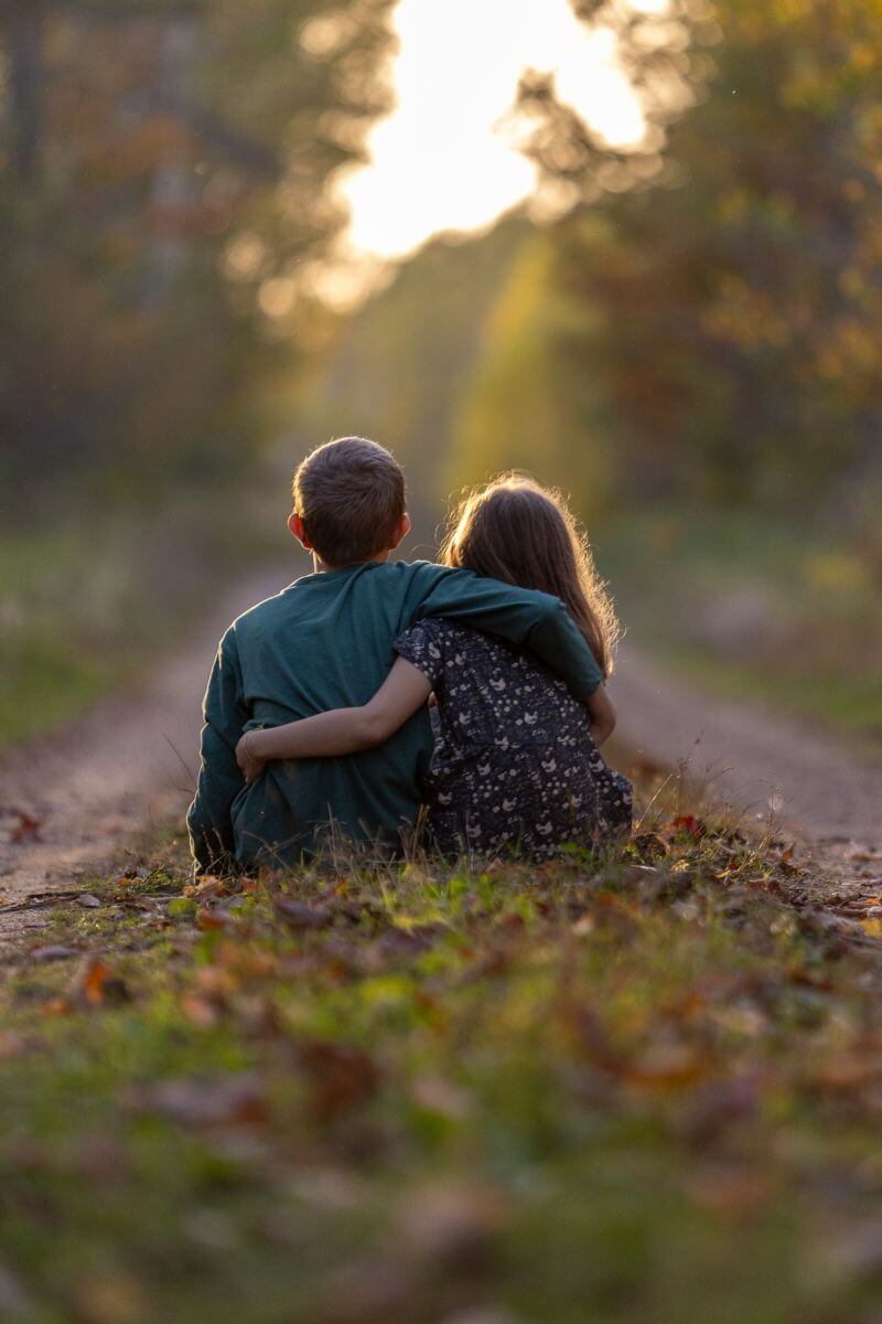 two kids look down a path