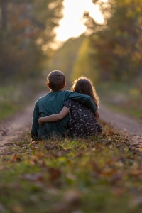 two kids look down a path